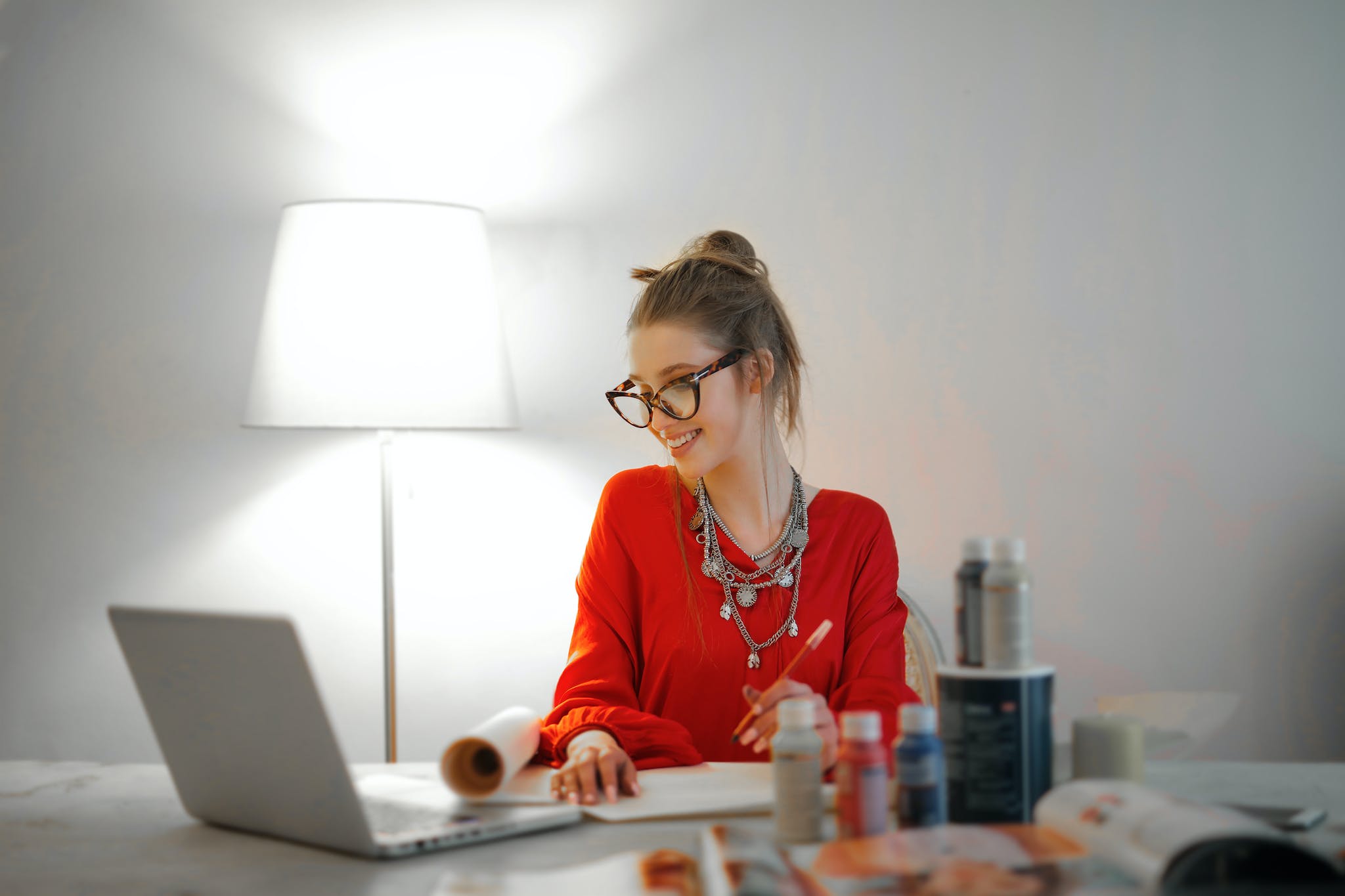 Woman in Red Long Sleeve Shirt Looking At Her LAptop