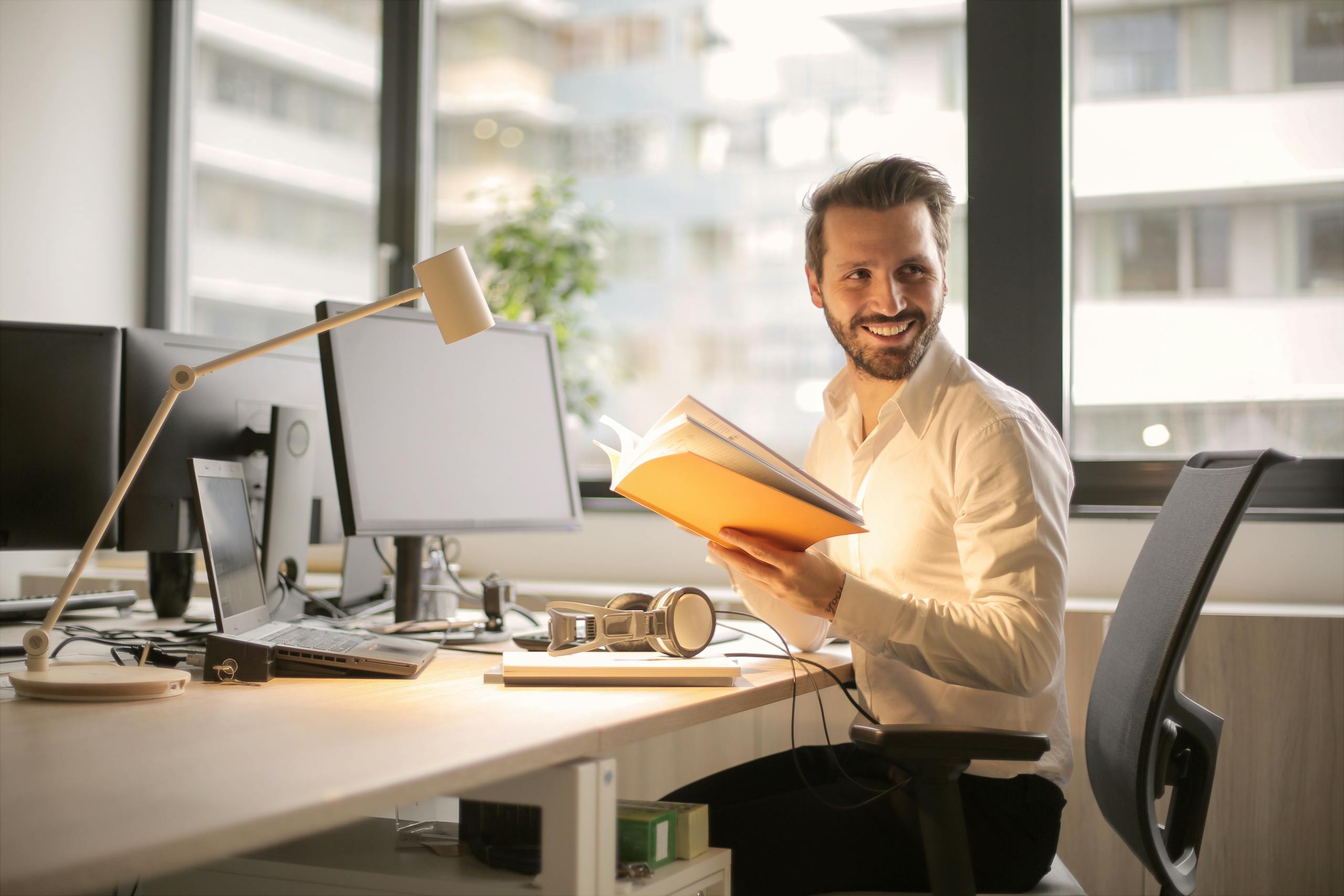 Photo of Man Holding a Book - work-life balance